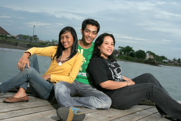 three asian fun on pier