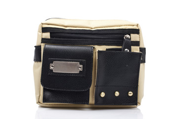 A bicolor handbag reflected on white background