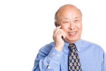 A senior asian businessman talking on the phone