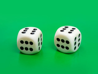Two gambling dices ( only six ) on green background