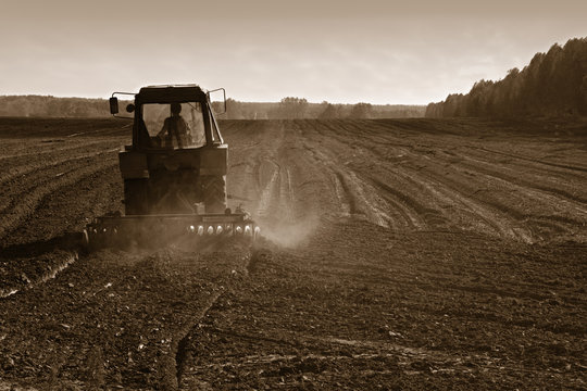 agricultural tractor cultivating land