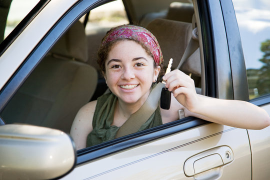 Cute teen girl excited to have the car keys.