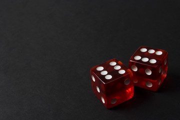 Two Red Dice on Dark Background