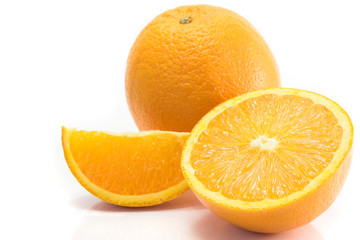 Whole, halved and quartered oranges, isolated on white.