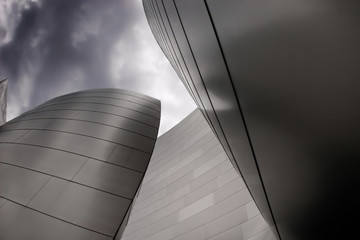 modern curvet building with metal on a dark cloudy sky
