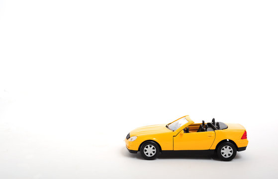 A yellow toy car on white background © Orlando Florin Rosu