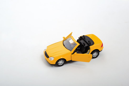 A simple yellow toy car on white background © Orlando Florin Rosu