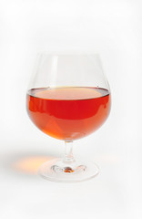 Cognac in a brandy snifter, on white background - close up