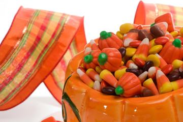 Orange pumpkin filled with delicious Halloween candies.