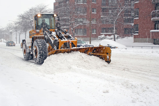 Truck with shovel remove snow.