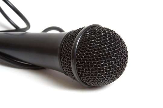 Black microphone over white background