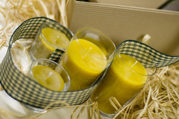 five yellow candles, ribbon and box