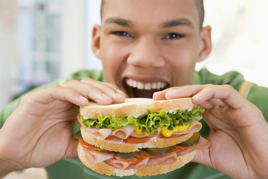 Teenage Boy Eating Sandwich