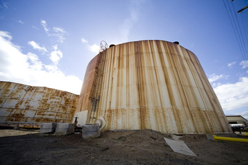 Wide angle image of an old tank used to hold molasses.