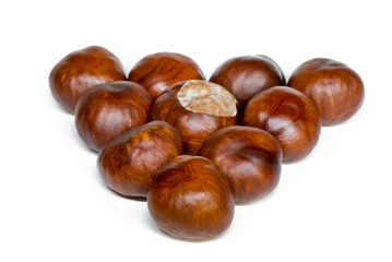 a few brown chestnuts are on a white background