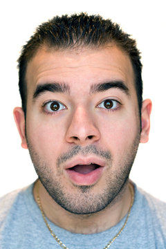 A young man with a surprised or scared look on his face.