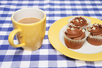 Mug of coffee and cup cakes