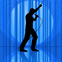 silhouette singing to a microphone on theatrical stage