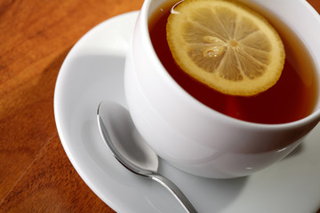 Hot teacup with lemon.