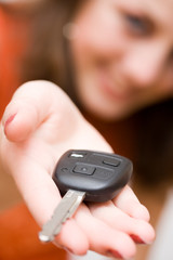 Young sales woman offering car keys