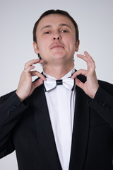 handsome man in suit with bow-tie is smiling