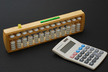 Traditional abacus and modern calculator