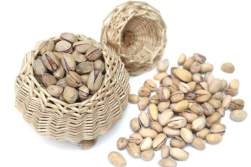 It is a lot of nuts in a basket on a white background