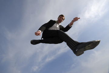 emotional young businessman has jumped up