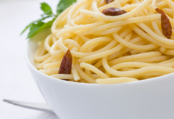 spaghetti with chili pepper and olive oil on white bowl