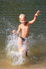 The boy was swimming in the river and splash water