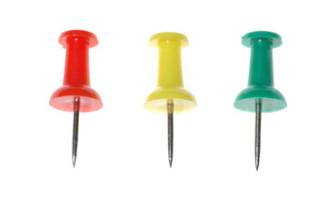 Three drawing pins of different color isolated on white