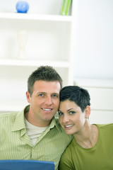 Fototapeta premium Happy love couple cuddling at home, smiling.