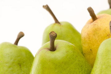 yellow and green pears on white with copy space