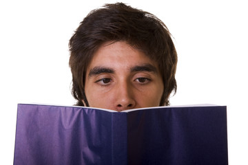 a young man reading a blue book (isolated on white)