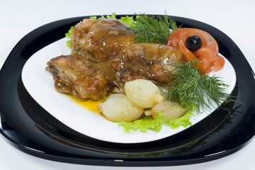 Chicken legs in sauce with stewed onions and tomatoes