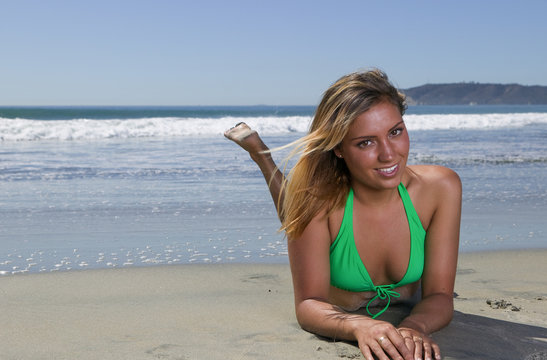 Sexy Blond laying on the beach in a Bikini