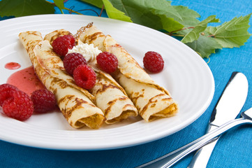 Pancakes with cream and raspberries