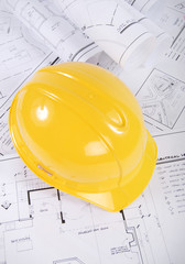 Building plans and yellow hardhat