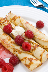 Pancakes with cream and raspberries