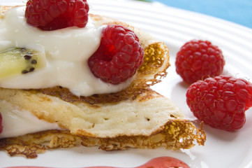 Pancakes with cream and raspberries
