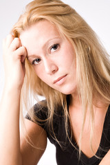 Studio portrait of a young blond girl looking pensive