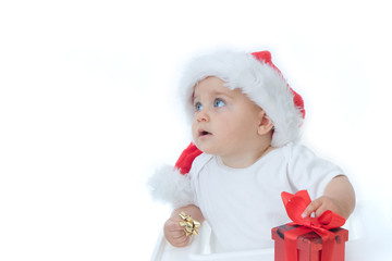 little, cute baby boy wearing Christmas hat, on white