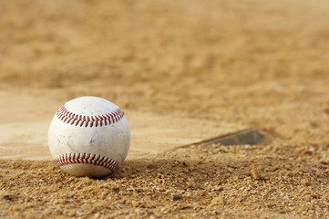 one baseball on home plate at a sports field - 9862547
