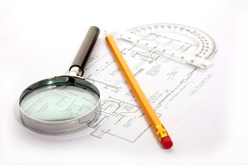 Small magnifier, protractor and  pencil   on  the flat plan