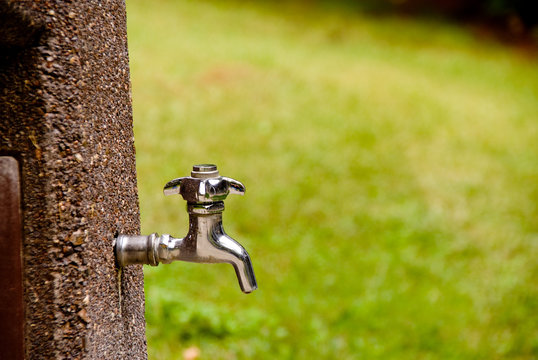 A Outdoor Spigot Ready To Spit Out Water.