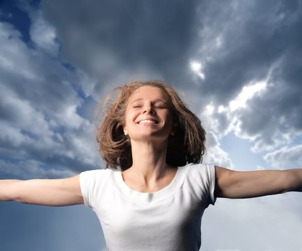 portrait of a happy woman with sky background