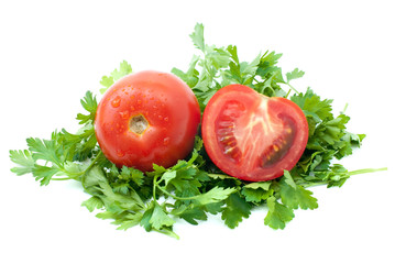 Ripe tomato and half with some parsley isolated on the white