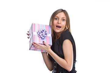 Very surprised girl holding a gift box