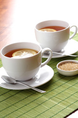 Hot teacup with lemon and sugar.