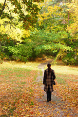 Young woman walking in an autumn park